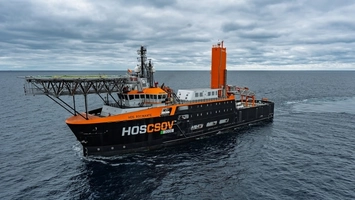 Black and orange offshore support vessel HOS Rocinante underway at sea with crane and deck equipment visible